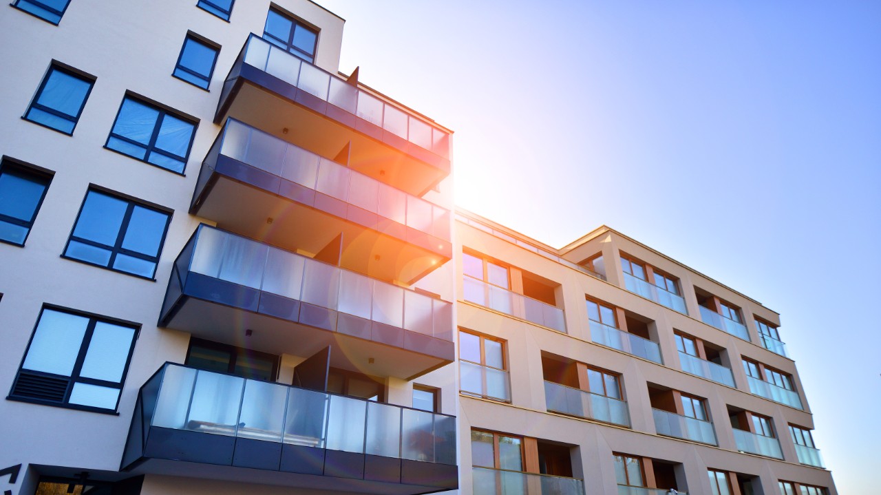 New apartment building on a sunny day. Modern residential architecture. The apartment is waiting for new residents.